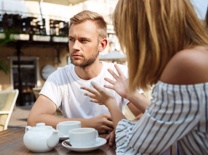 Man and woman having a serious conversation outdoors, highlighting unexpected things men didn’t know about women dating them.