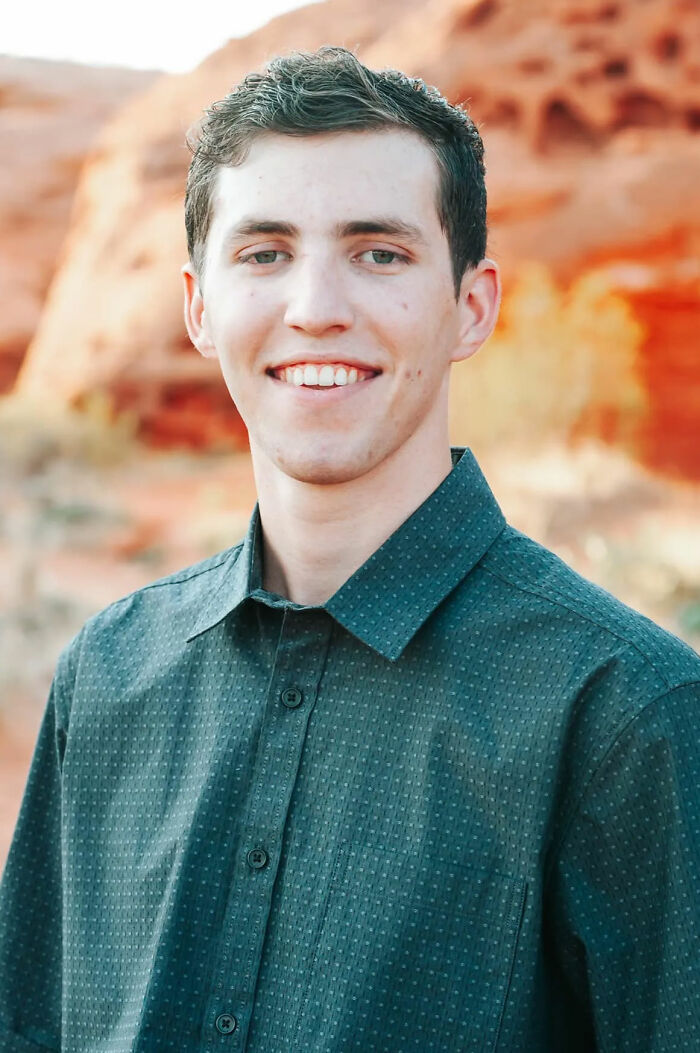 Young man smiling outdoors with red rock formations in the background, related to Charlie Kirk assassin capture details. Young man smiling outdoors with red rock formations in the background, related to Charlie Kirk assassin capture details.
