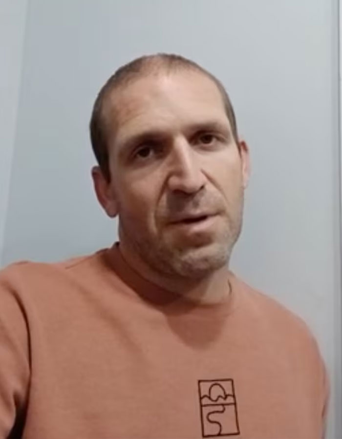 Man in brown sweatshirt speaking against a plain wall, related to husband's final texts to wife revealed story.