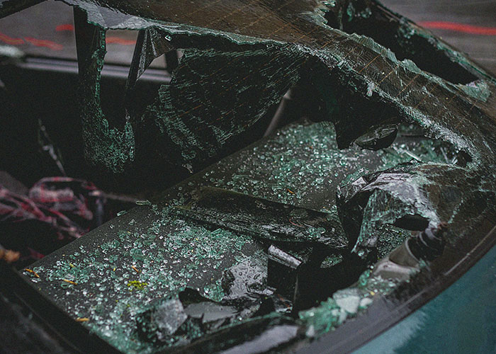 Shattered car window with broken glass scattered inside, illustrating terrifying true stories that are hard to believe.