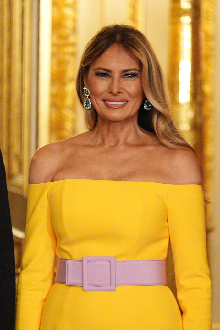 Melania Trump wearing a vibrant yellow optical illusion dress with a wide lavender belt at Windsor banquet event Melania Trump wearing a vibrant yellow optical illusion dress with a wide lavender belt at Windsor banquet event