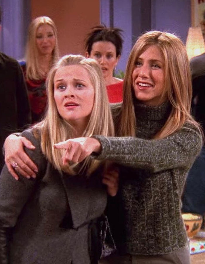 Jennifer Aniston and Reese Witherspoon together in a candid moment from a popular TV show episode.