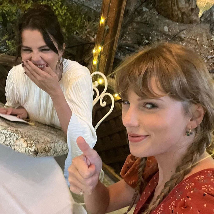 Taylor Swift giving a thumbs up at Selena Gomez's wedding, capturing a joyful moment between best friends.