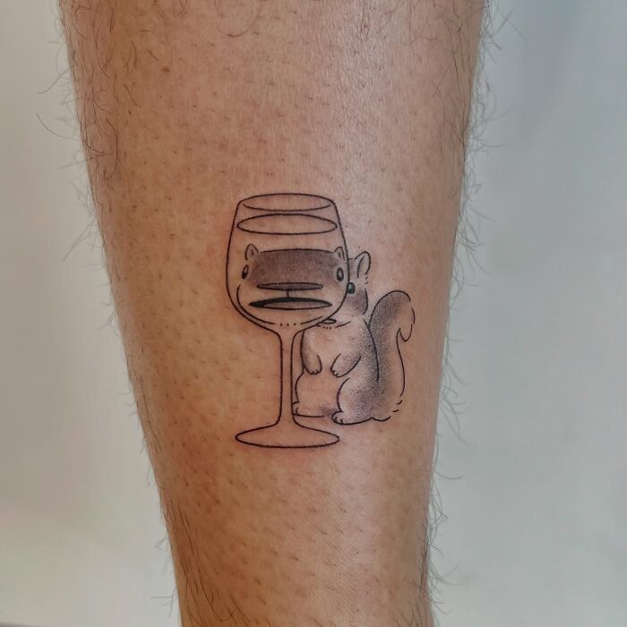 Minimalist squirrel tattoo with a wine glass, animal tattoo by Korean artist Buoy on leg skin.