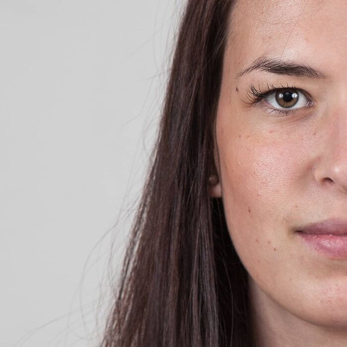 Woman with long brown hair and natural makeup, shown in a genetic portrait highlighting family DNA similarities.