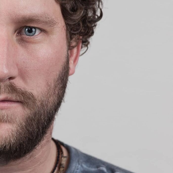 Portrait of a man showing unique curly hair and beard, illustrating strong family DNA in side-by-side genetic portraits.