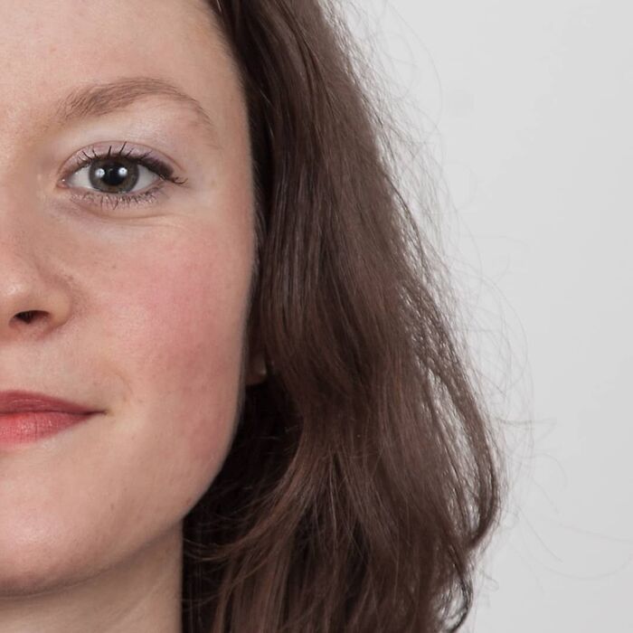 Young woman with expressive eyes and natural look, illustrating family DNA resemblance in genetic portraits concept.