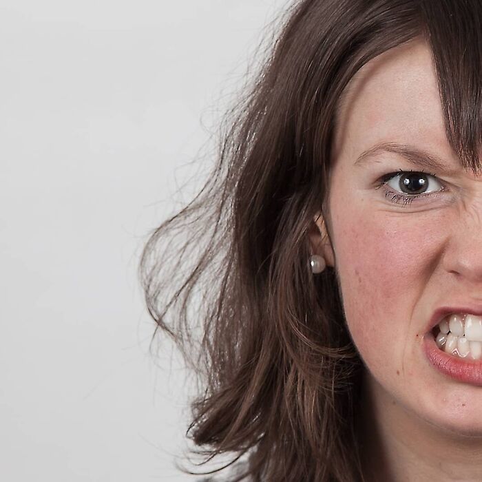 Woman showing two different facial expressions side-by-side, illustrating strong family DNA in a genetic portrait comparison.