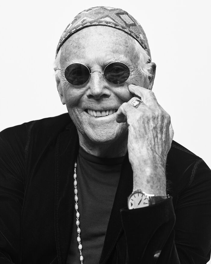 Giorgio Armani smiling in sunglasses and patterned cap, showcasing his legendary fashion designer style and charisma. Giorgio Armani smiling in sunglasses and patterned cap, showcasing his legendary fashion designer style and charisma.