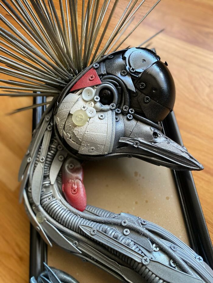 Intricate animal sculpture made from recycled trash and metal parts showcasing creative transformation and artistic craftsmanship.