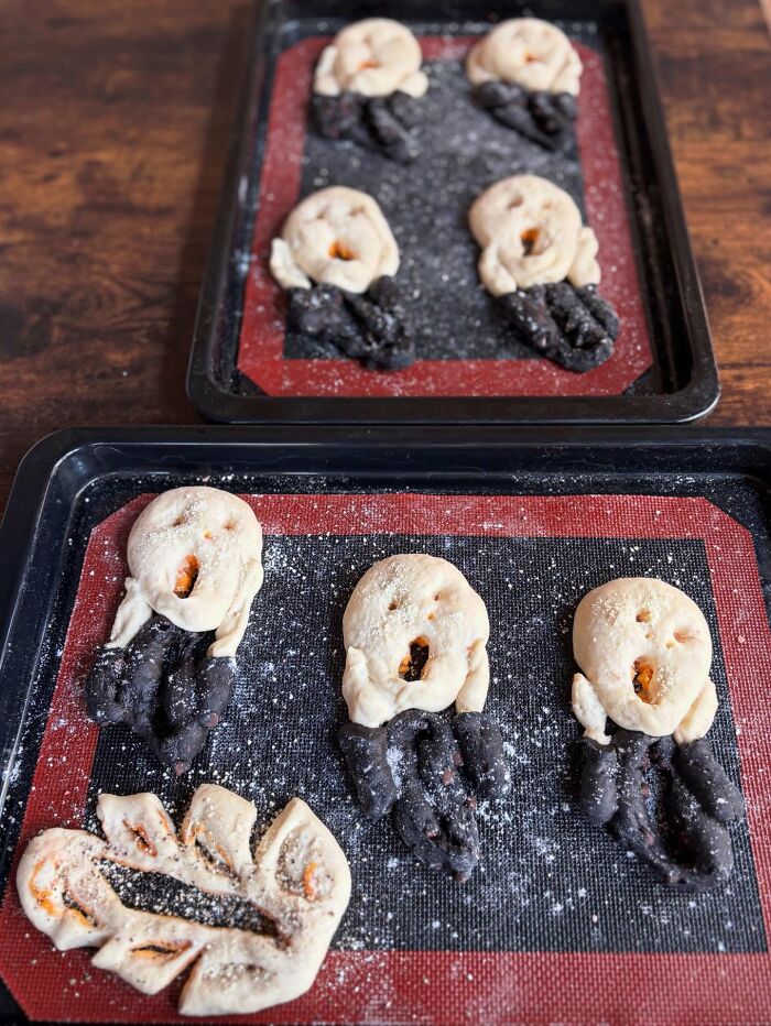 Basket of creative homemade bread shaped like expressive faces with black and golden brown dough, inspired by Japanese kids' meals.