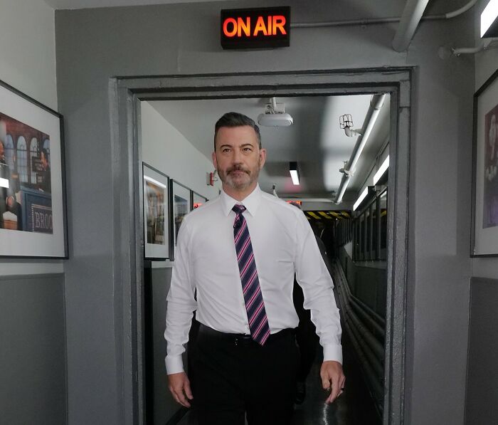 Jimmy Kimmel walking in a hallway under an on air sign before a tearful return amid mutiny threat from staff. Jimmy Kimmel walking in a hallway under an on air sign before a tearful return amid mutiny threat from staff.