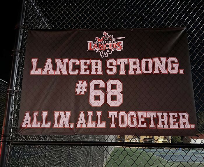 Banner at a football field with Lancer Strong message supporting school action against football player in incident