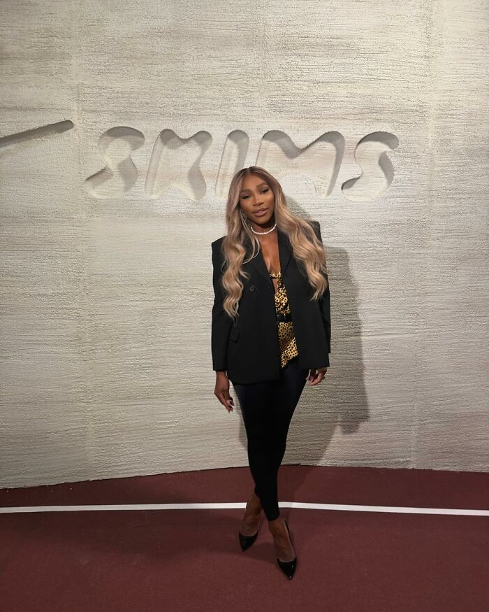 Serena Williams posing in front of a textured wall with SKIMS logo, related to heated reactions over cotton plant decoration. Serena Williams posing in front of a textured wall with SKIMS logo, related to heated reactions over cotton plant decoration.