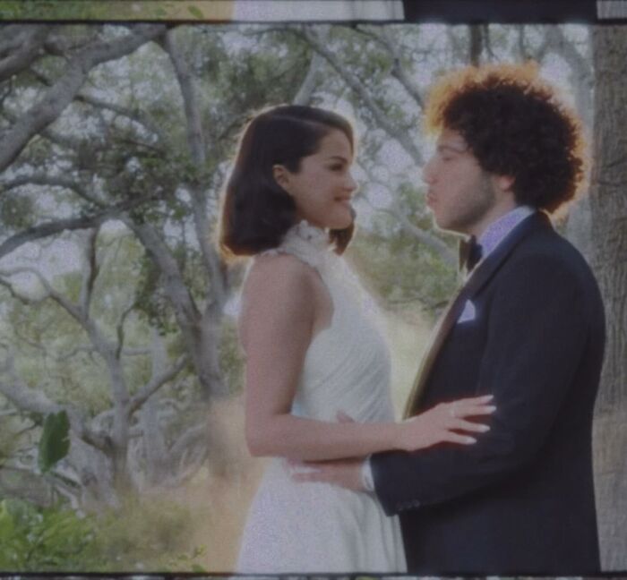 Selena Gomez and Benny Blanco embracing outdoors at their wedding, capturing a star-studded moment. Selena Gomez and Benny Blanco embracing outdoors at their wedding, capturing a star-studded moment.