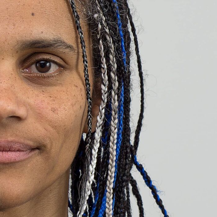 Close-up portrait of a young person with braided hair, illustrating diverse family DNA traits in a genetic portrait series.