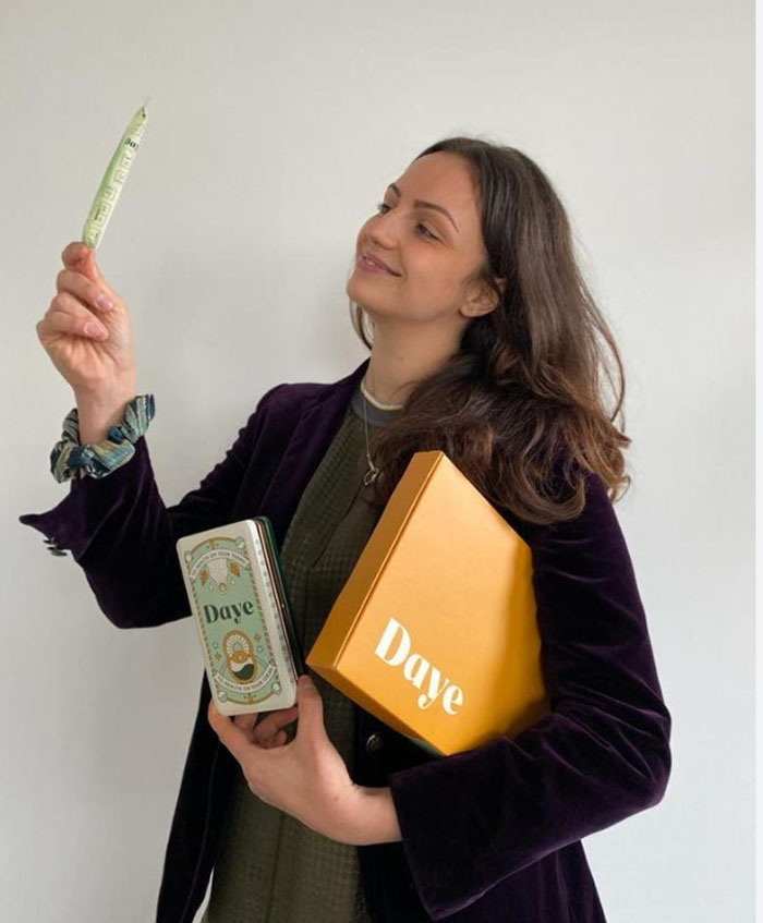 Young woman holding boxes and a product, related to the story of hair and teeth found inside a girl mistaken for pregnancy.