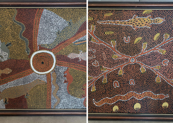 Two framed Aboriginal dot paintings featuring animals and traditional patterns, a hidden gem discovered in a new home.