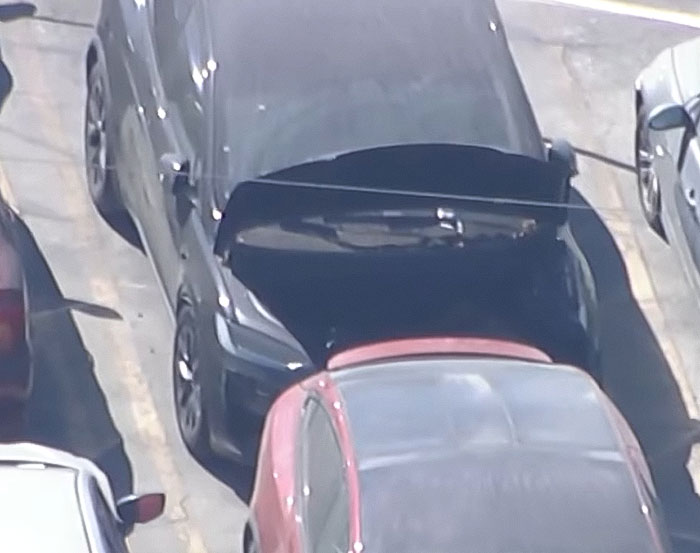 Black Tesla with open trunk parked in a lot linked to decomposing body found and singer breaking silence.