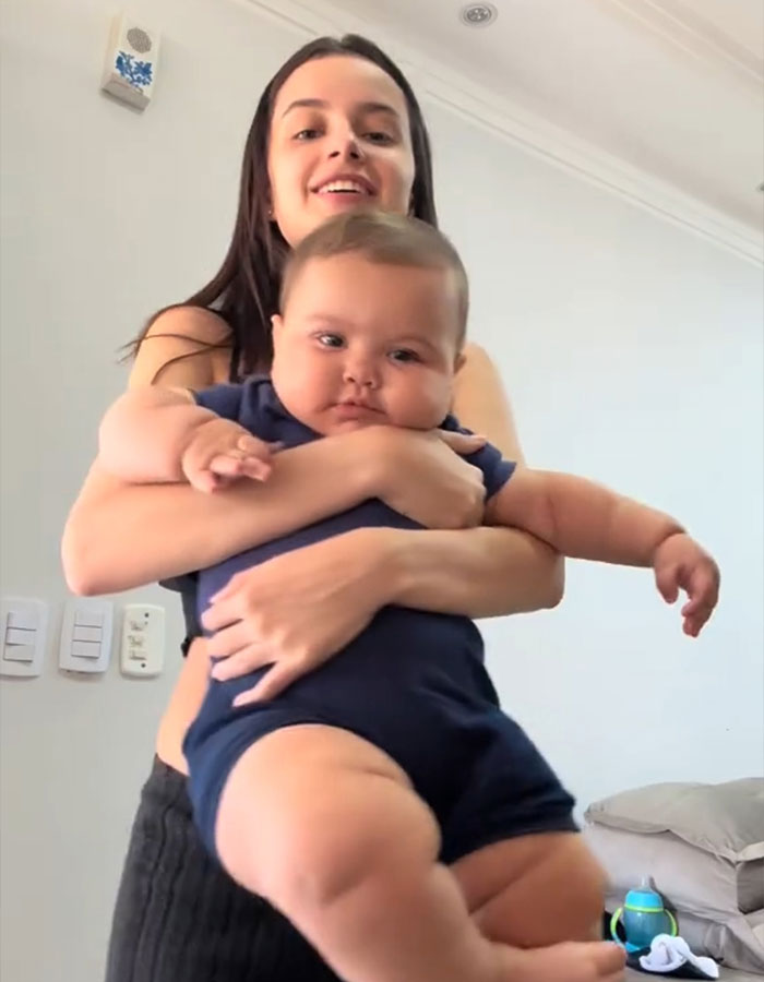 Woman holding a large baby indoors, illustrating concerns raised by doctors over rise in giant baby births. Woman holding a large baby indoors, illustrating concerns raised by doctors over rise in giant baby births.