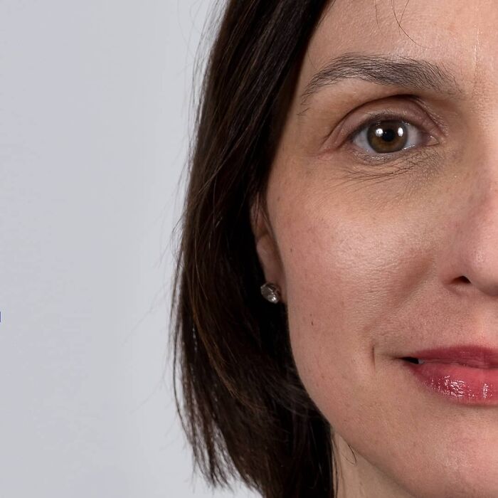 Woman with short dark hair and hoop earrings in a close-up portrait highlighting family DNA resemblance.