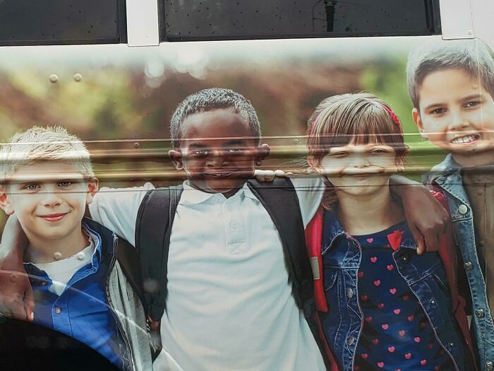 Bus side advertisement featuring kids with backpacks, an example of advertising placement fails that made people laugh.