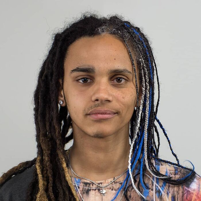 Close-up portrait of a young person with braided hair, illustrating diverse family DNA traits in a genetic portrait series.