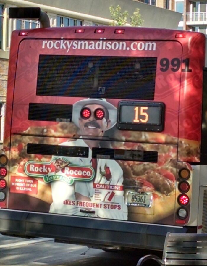 Bus advertisement with a man whose eyes align with red bus lights, an example of advertising placement fails that made people laugh.