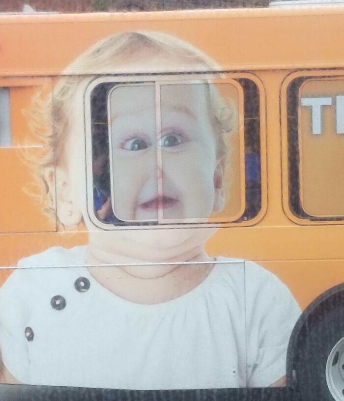 Baby face distorted by bus window frame in a humorous example of advertising placement fails that made people laugh.