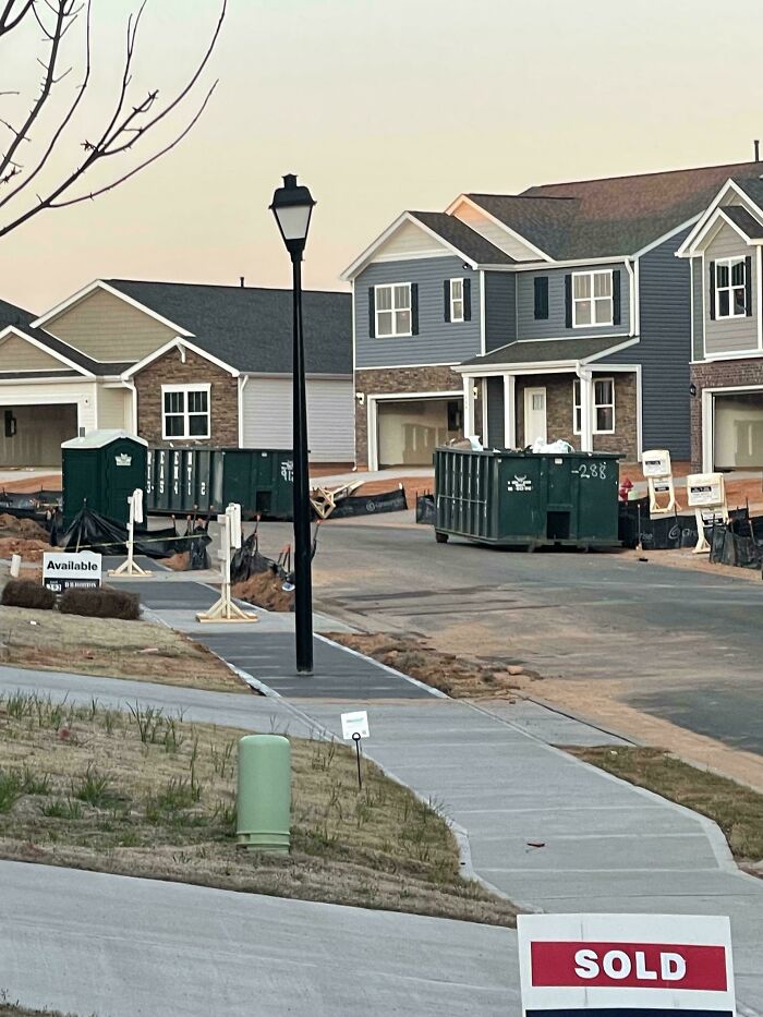 New housing construction with poorly done sidewalk and landscaping showing hilariously bad jobs that were rushed to get it over with.
