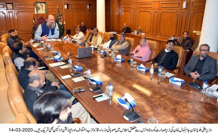 Group of people in a formal meeting room, discussing strategies, illustrating companies that failed miserably on social media.