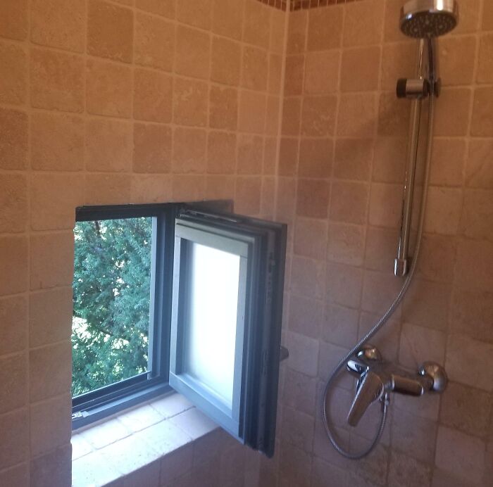 Poorly installed window in a tiled shower area, an example of hilariously bad jobs done just to get it over with.