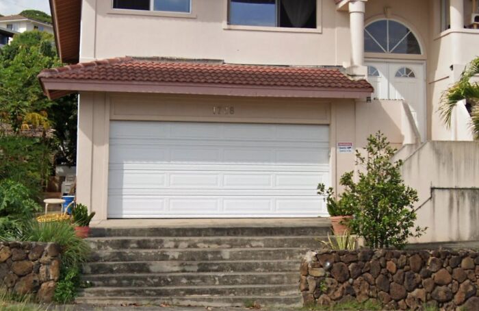 Garage door painted shut in a hilariously bad job done by someone who just wanted to get it over with and it shows