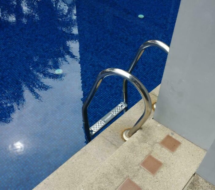 Pool ladder installed incorrectly, showing hilariously bad jobs done by someone who just wanted to get it over with.