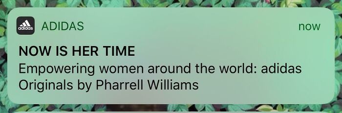 Adidas social media post promoting empowerment with a controversial caption linked to a campaign by Pharrell Williams.