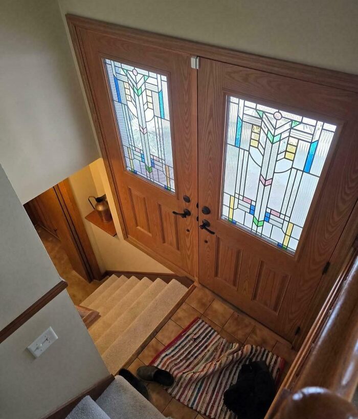 Double front doors installed upside down with mismatched handles, showing a hilariously bad job done to get it over with.