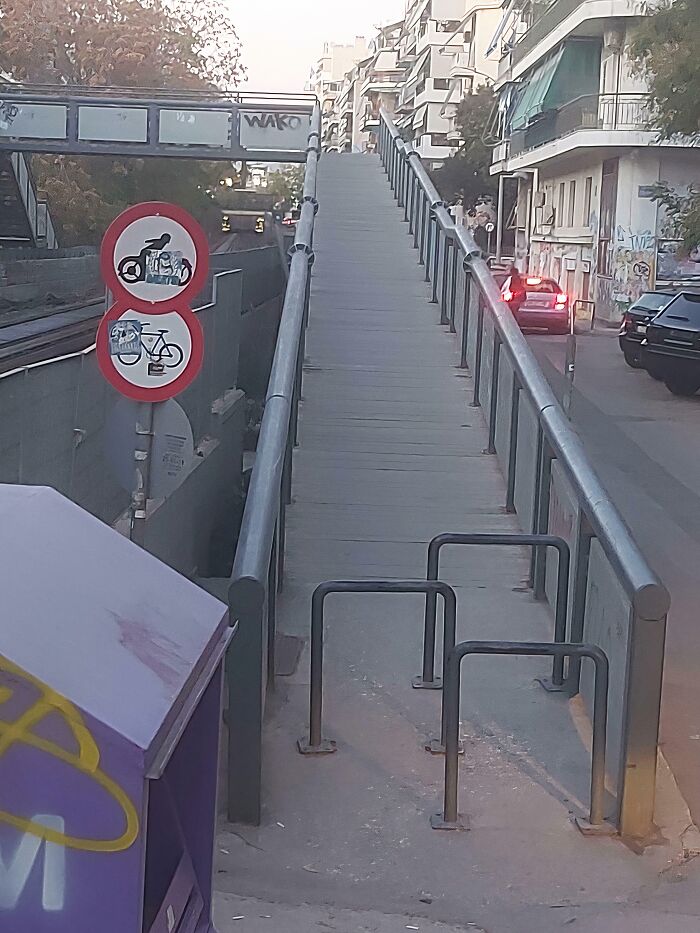 Ramp with steep incline and metal barriers showing hilariously bad jobs done by someone who just wanted to get it over with.