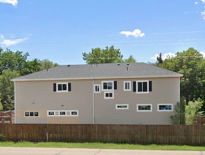 House exterior with many mismatched and poorly installed windows illustrating hilariously bad jobs done.