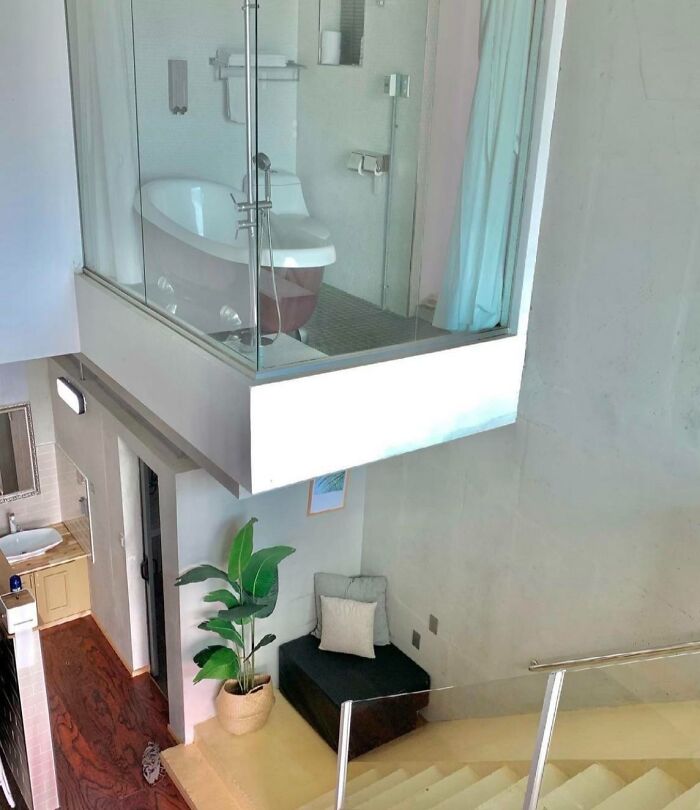 Bathroom installed above living space with poor job e*******n and visibly bad design in a small modern apartment.
