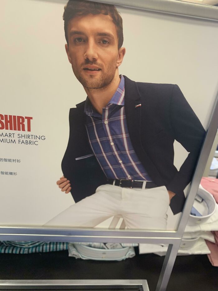 Model with distorted arm and oversized torso due to Photoshop fails in a clothing ad for smart shirting premium fabric.
