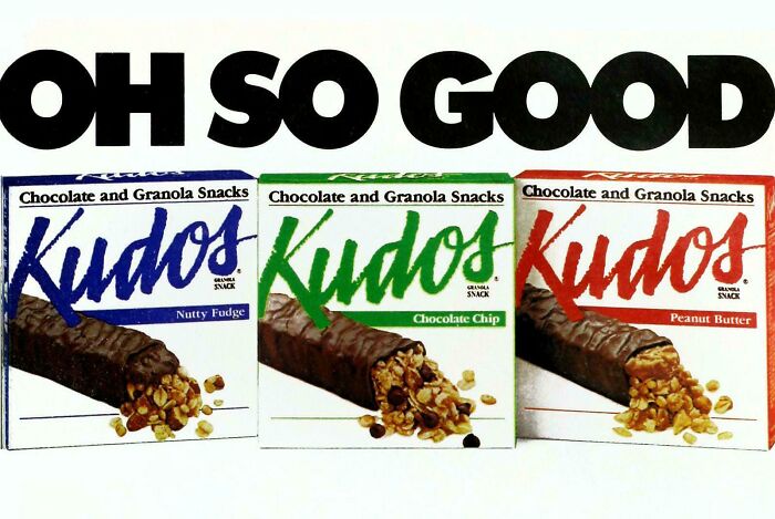 1990s granola snack bars Kudos in Nutty Fudge, Chocolate Chip, and Peanut Butter flavors with retro packaging.