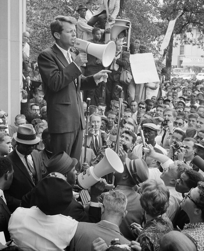 Civil rights leader speaking to a crowd with megaphones during a historic protest, illustrating false history facts.