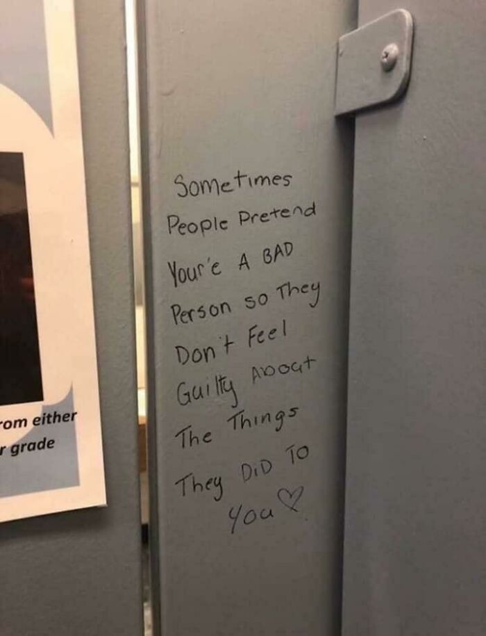Handwritten vandalism on public property stating a message about guilt and pretending someone is a bad person.