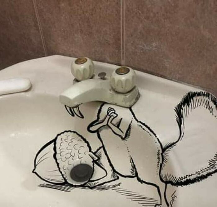 Creative vandalized public property showing a squirrel drawing interacting with a faucet as its head in a bathroom sink.
