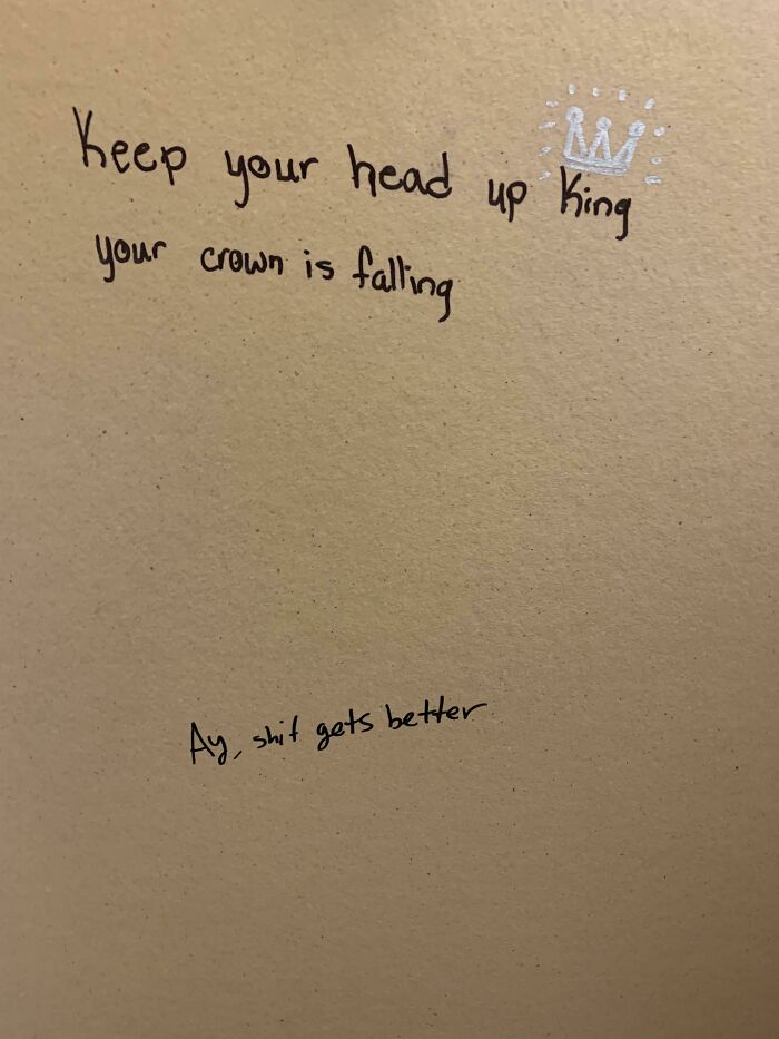 Graffiti vandalized public property with an encouraging message and a small crown drawn on a wall.