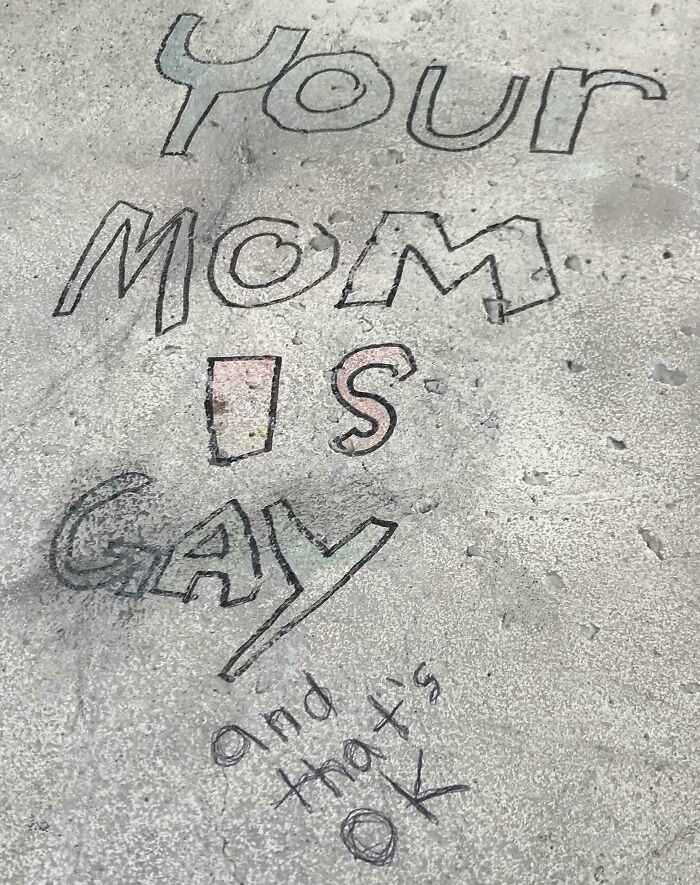 Graffiti vandalism on a concrete surface with playful and colorful text as public property art.