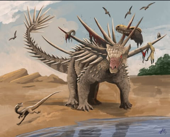 Extinct creature with metal-like spikes and armored body standing near water, surrounded by smaller prehistoric animals and flying reptiles.