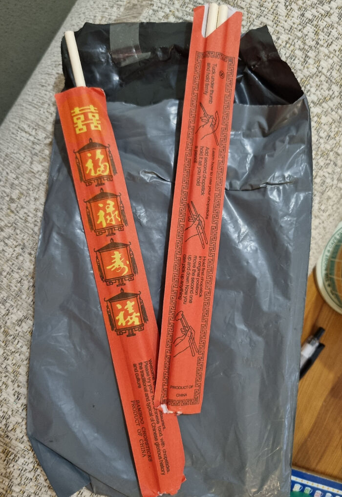 Pair of red chopstick sleeves with Chinese characters and instructions, photographed over a gray package, showing unhinged online selling.