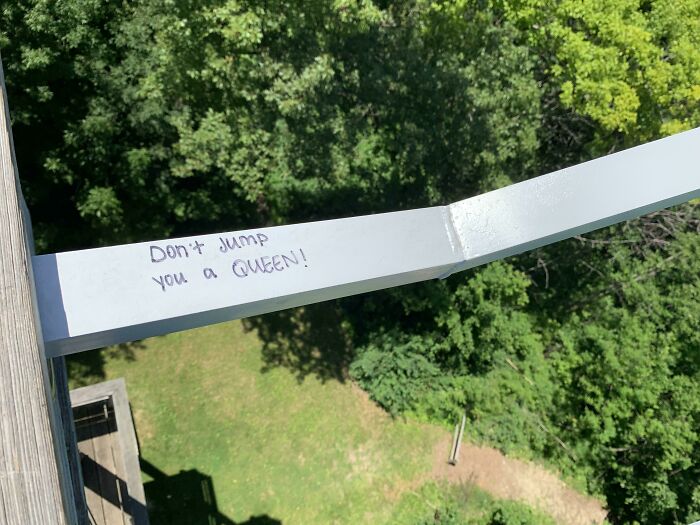 Graffiti on public property reads don't jump you a queen, showcasing creative vandalized public property message.