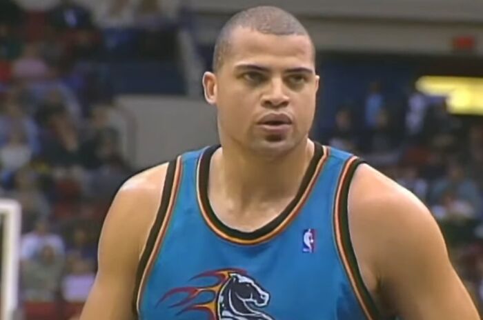 Basketball player in a teal jersey on court, representing celebrities who vanished without a trace in conspiracy theories.